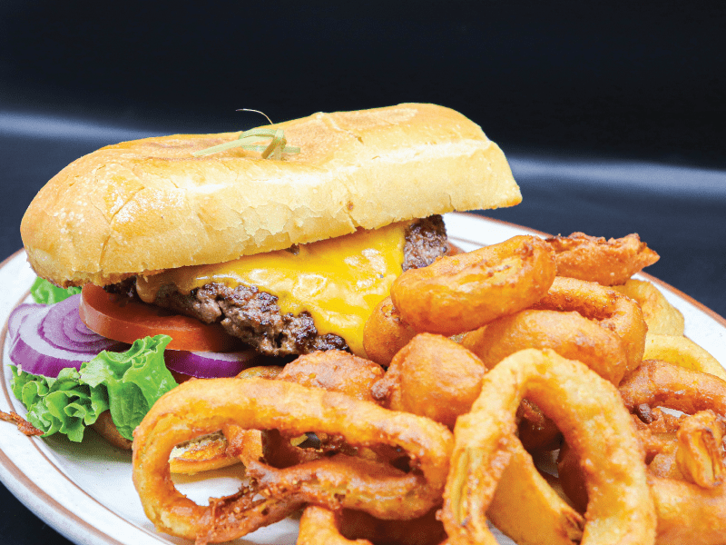Half pound ground chuck on a french roll with choice of cheese, lettuce, onion, tomato, and pickles served with onion rings. At Jack's Coffee Shop the breakfast restaurant.