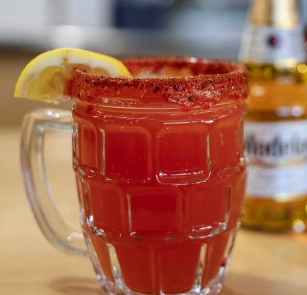 Classic Michelada rimmed with tajin and served with a lemon